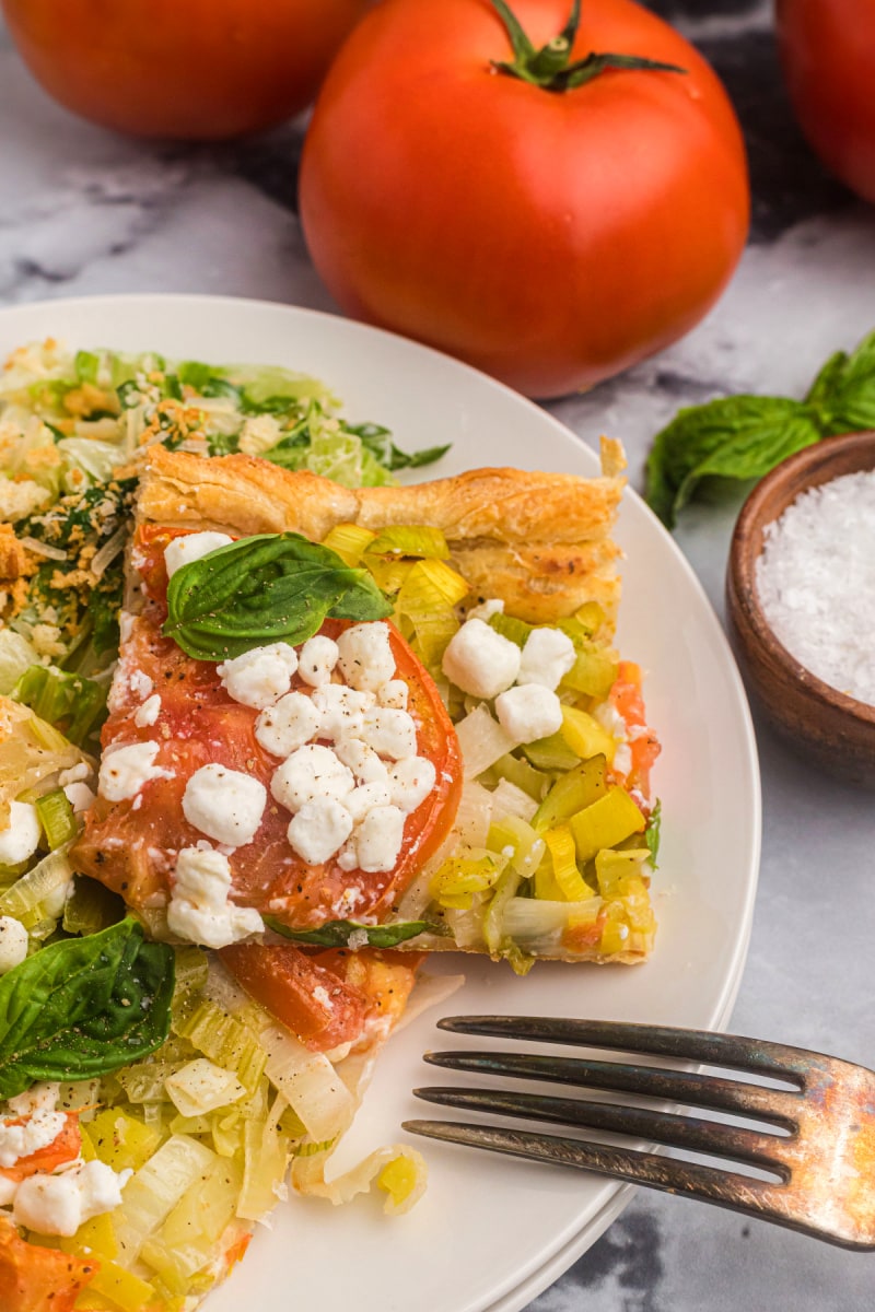 slice of tomato and goat cheese tart on plate