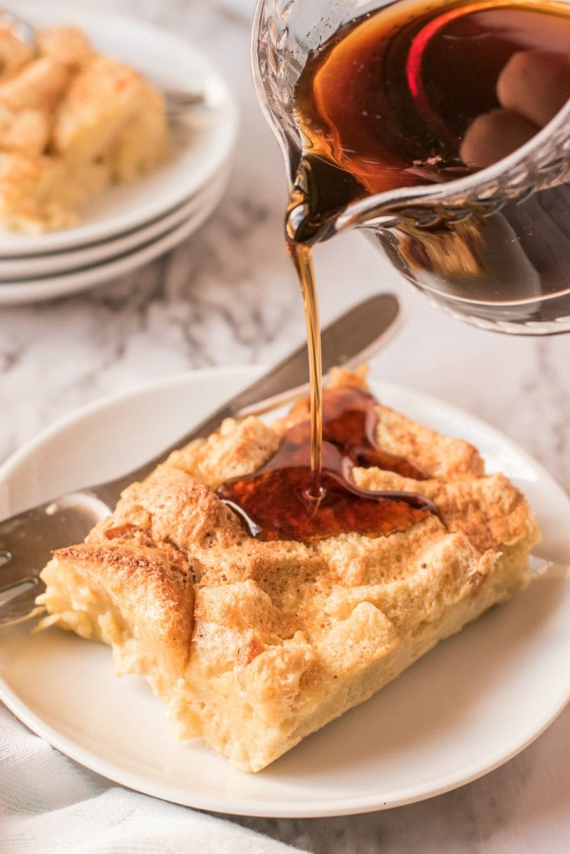 syrup poured over slice of maple custard bread pudding