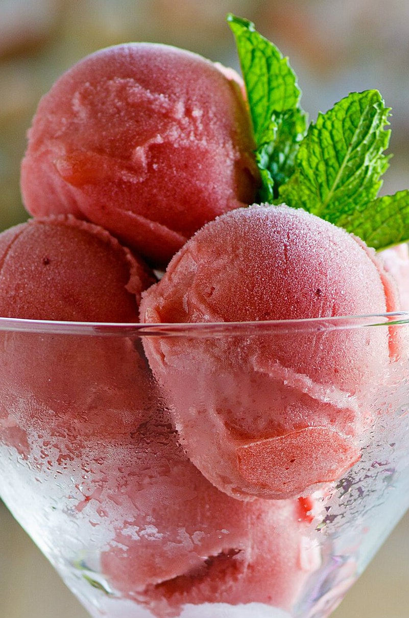 Scoops of Watermelon Sorbet in a glass and garnished with fresh mint