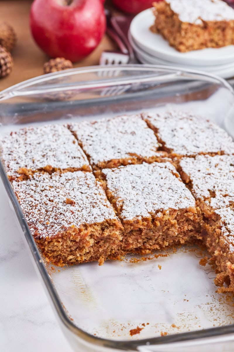 whole grain apple cake in baking pan sliced into pieces