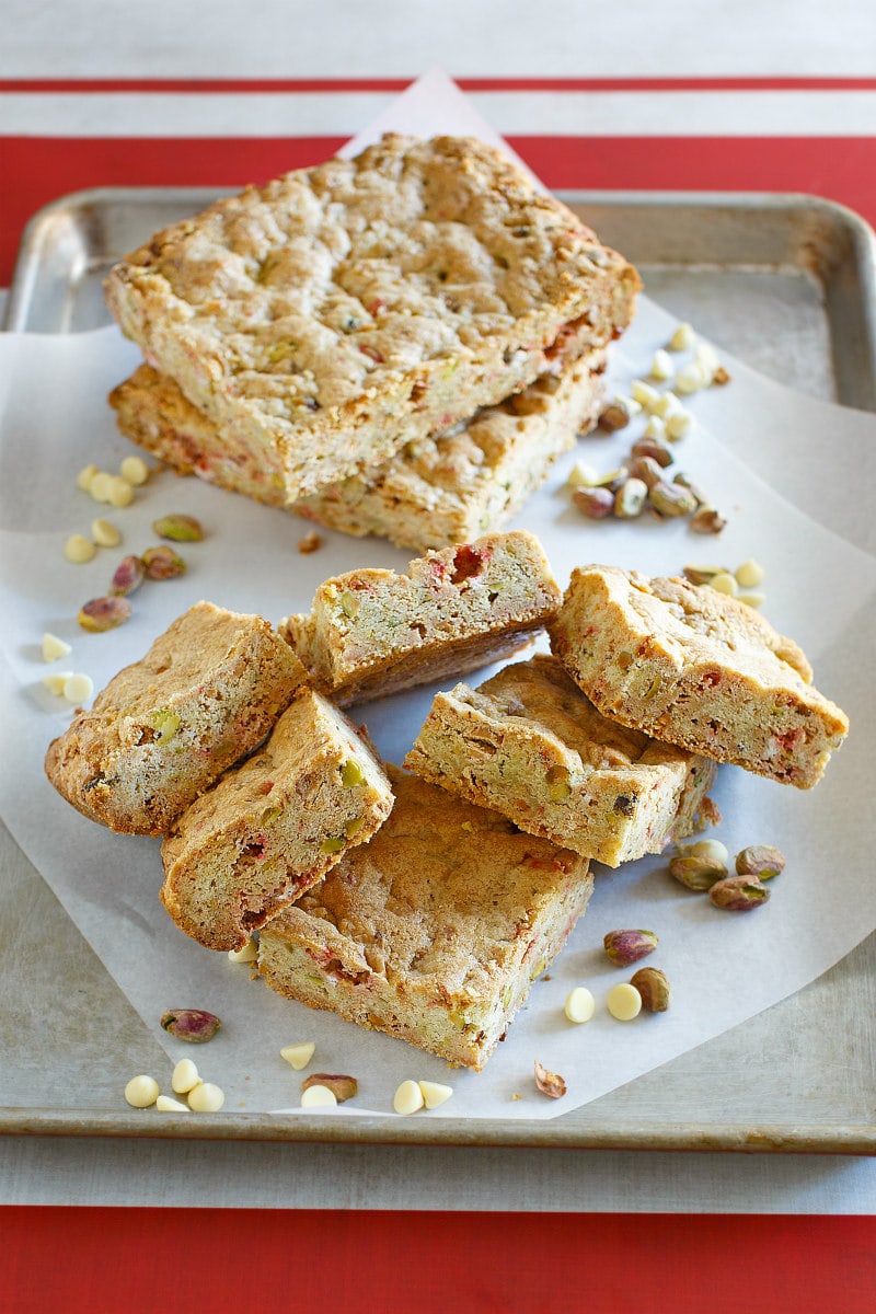 cutting white chocolate peppermint pistachio bars on cutting board