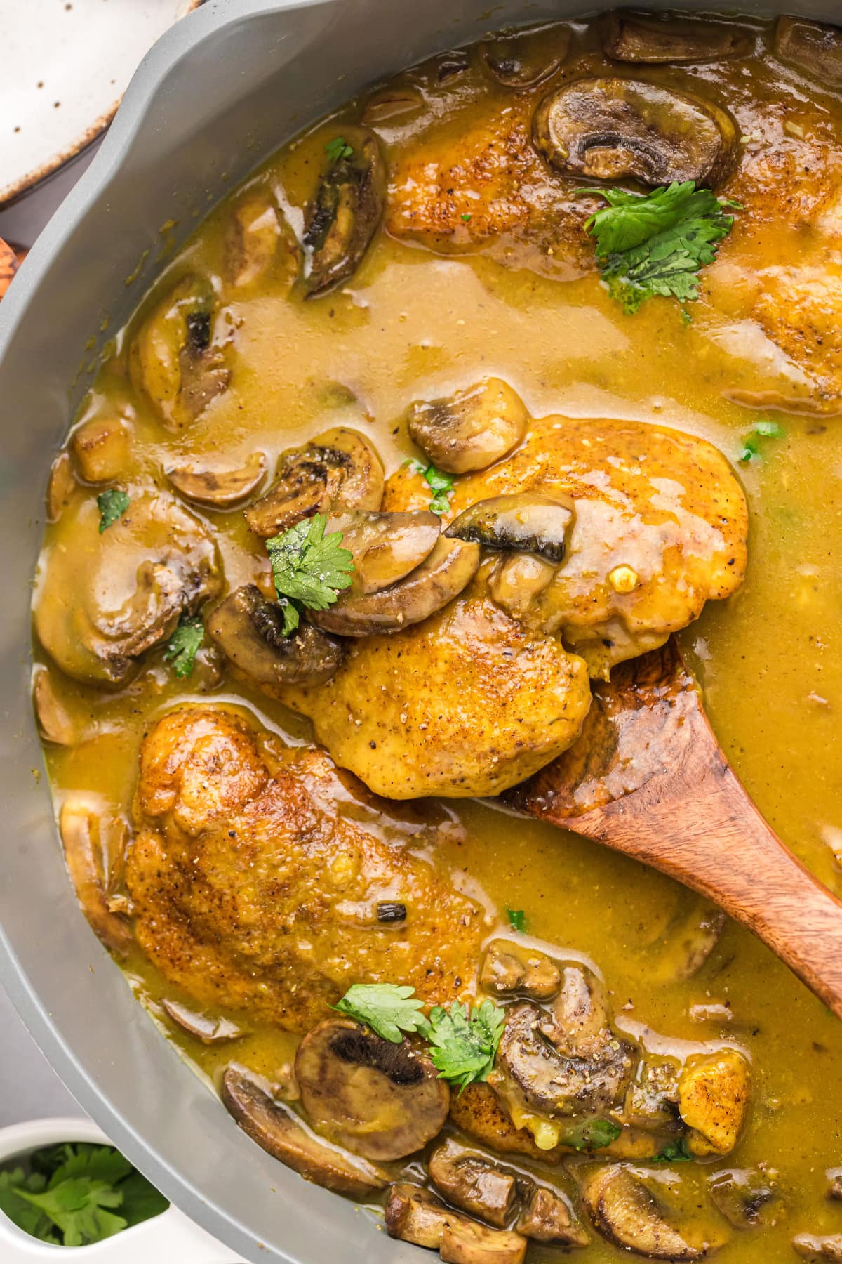 pan of amaretto chicken with spoon