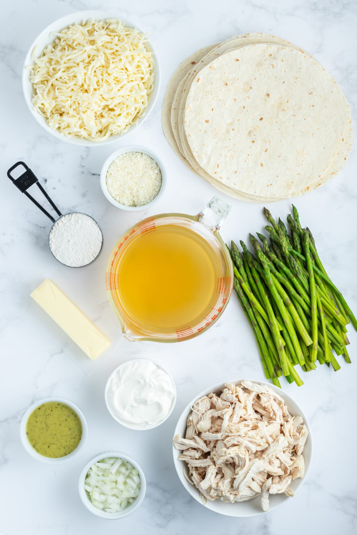 ingredients displayed for making asparagus and chicken enchiladas
