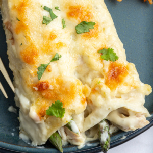 pinterest image for asparagus and chicken enchiladas