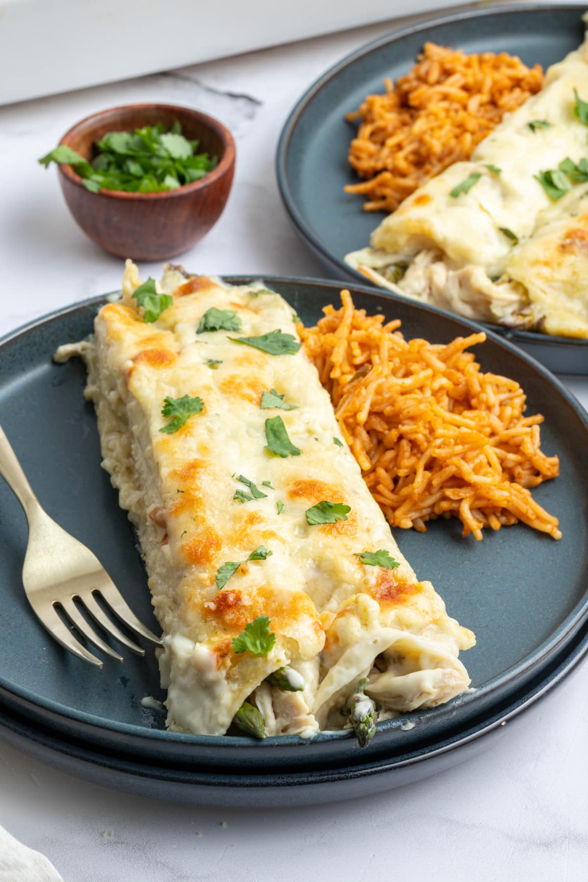 enchiladas on plate with fork