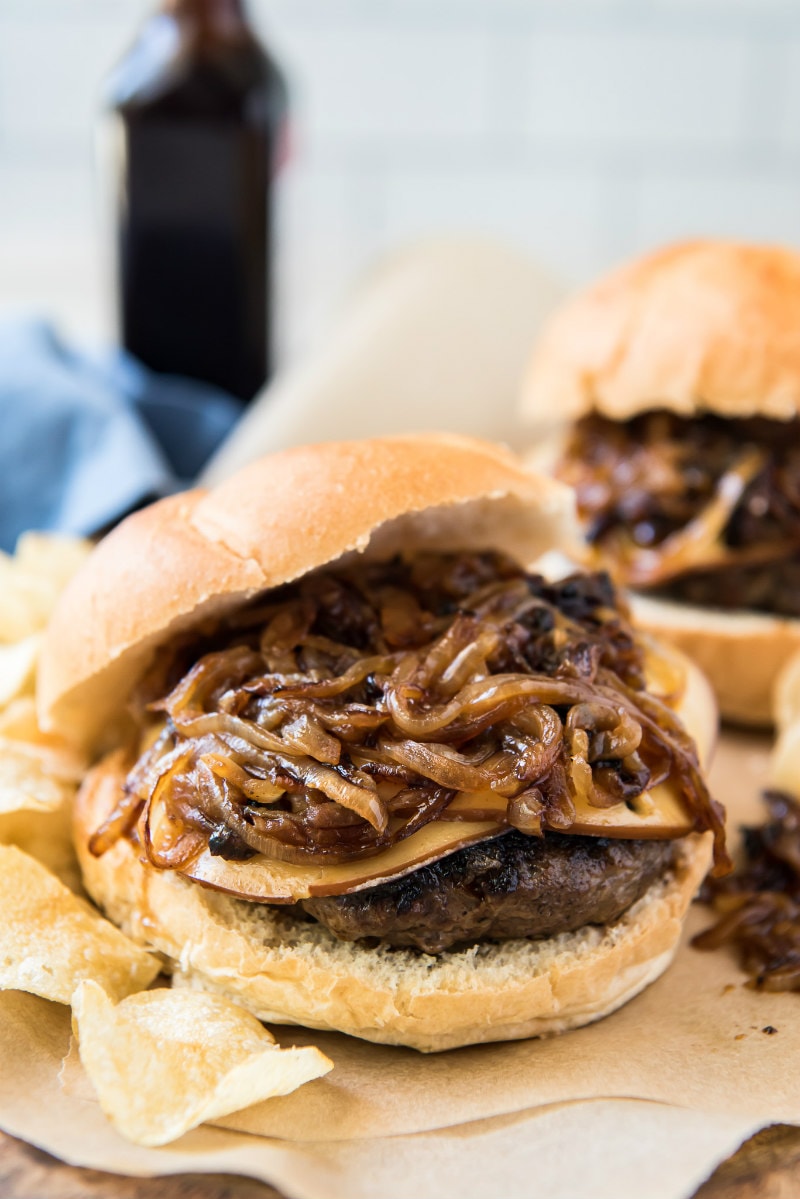 bacon bit burger piled high with sauteed onions