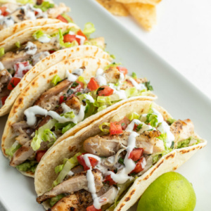 beer marinated chicken tacos on white platter