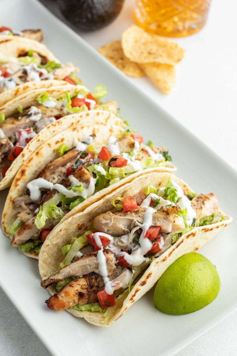 beer marinated chicken tacos on white platter