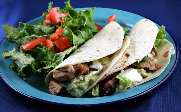 beer marinated chicken tacos on a plate with salad