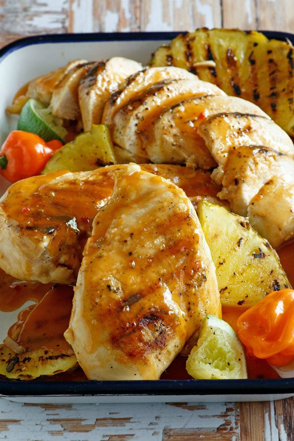 Chicken in a roasting pan with pineapple tequila marinade