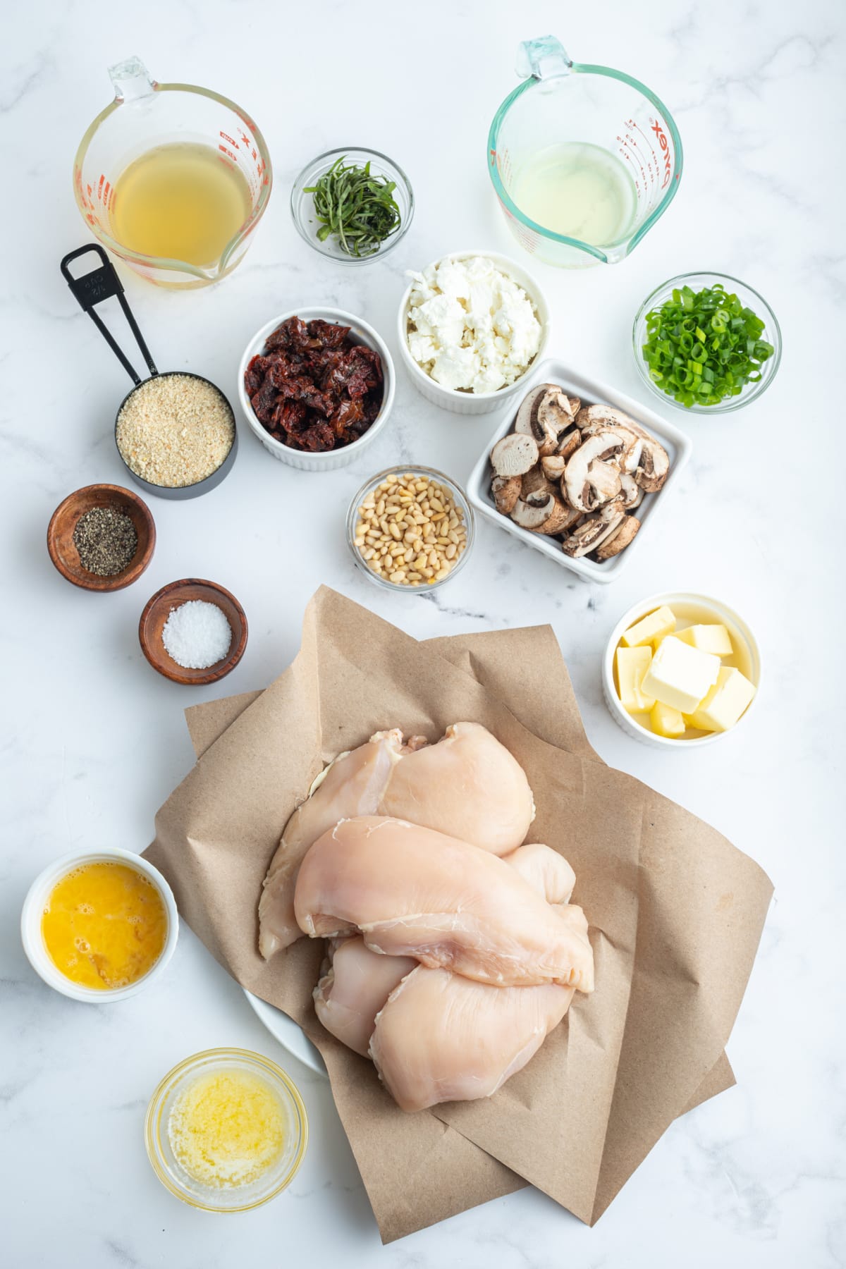 ingredients displayed for making chicken breasts stuffed with goat cheese and sun-dried tomatoes