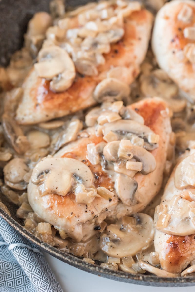 chicken in skillet with mushroom madeira sauce