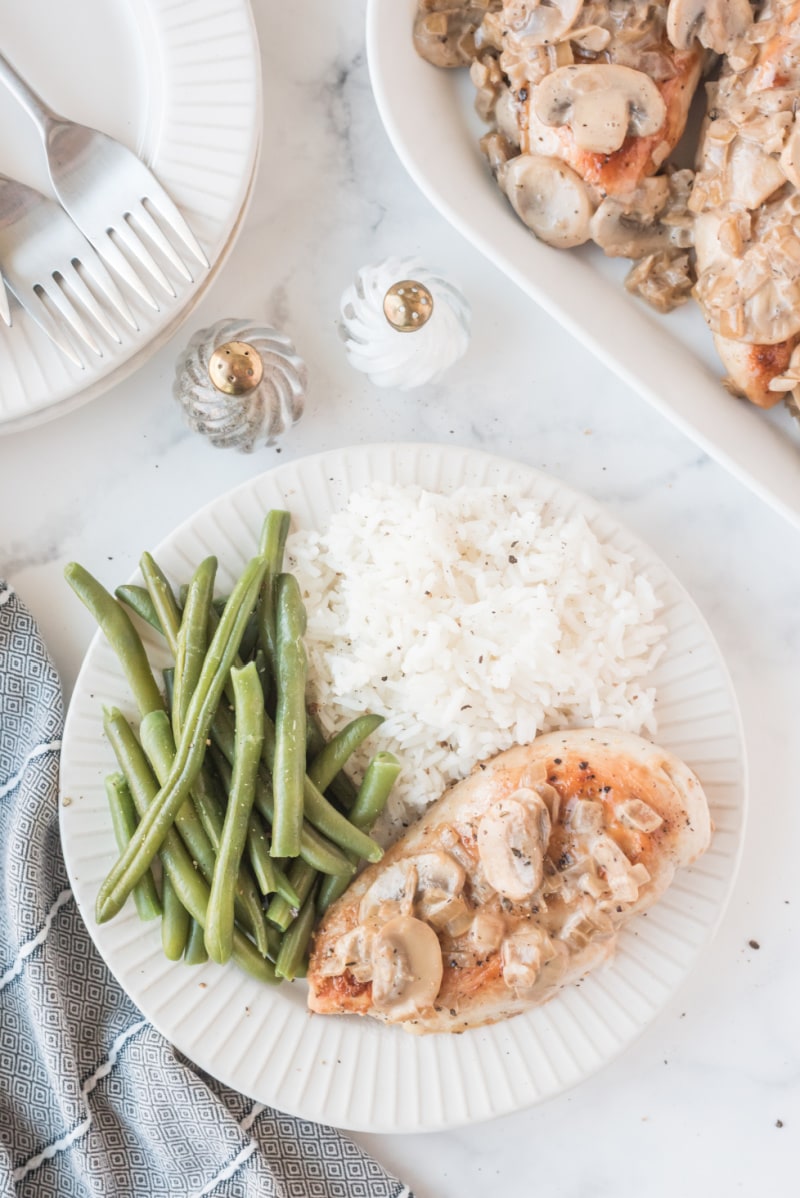 chicken plated with green beans and rice