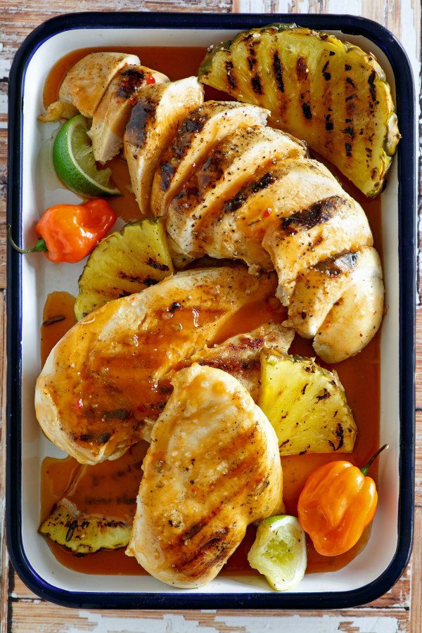 Chicken in a roasting pan with pineapple and tequila