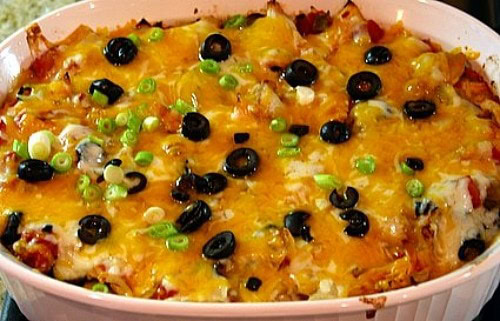 Chicken Enchilada Casserole recipe from RecipeGirl.com #chicken #enchilada #casserole #recipe #RecipeGirl Chicken Enchilada Casserole in white dish