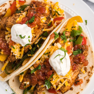 two tortillas stuffed with chicken fajitas on plate