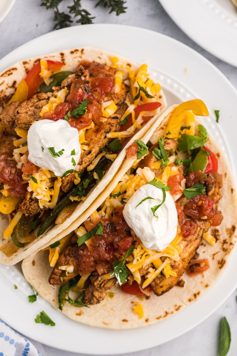 two tortillas stuffed with chicken fajitas on plate