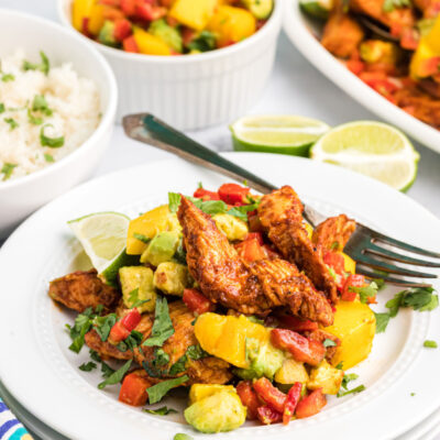 chili rubbed chicken with mango salsa on plate