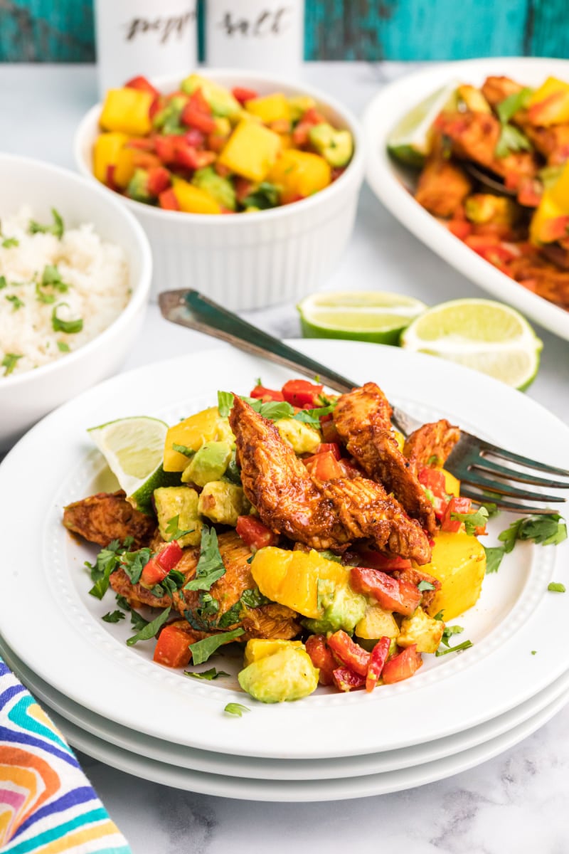 chili rubbed chicken with mango salsa on plate