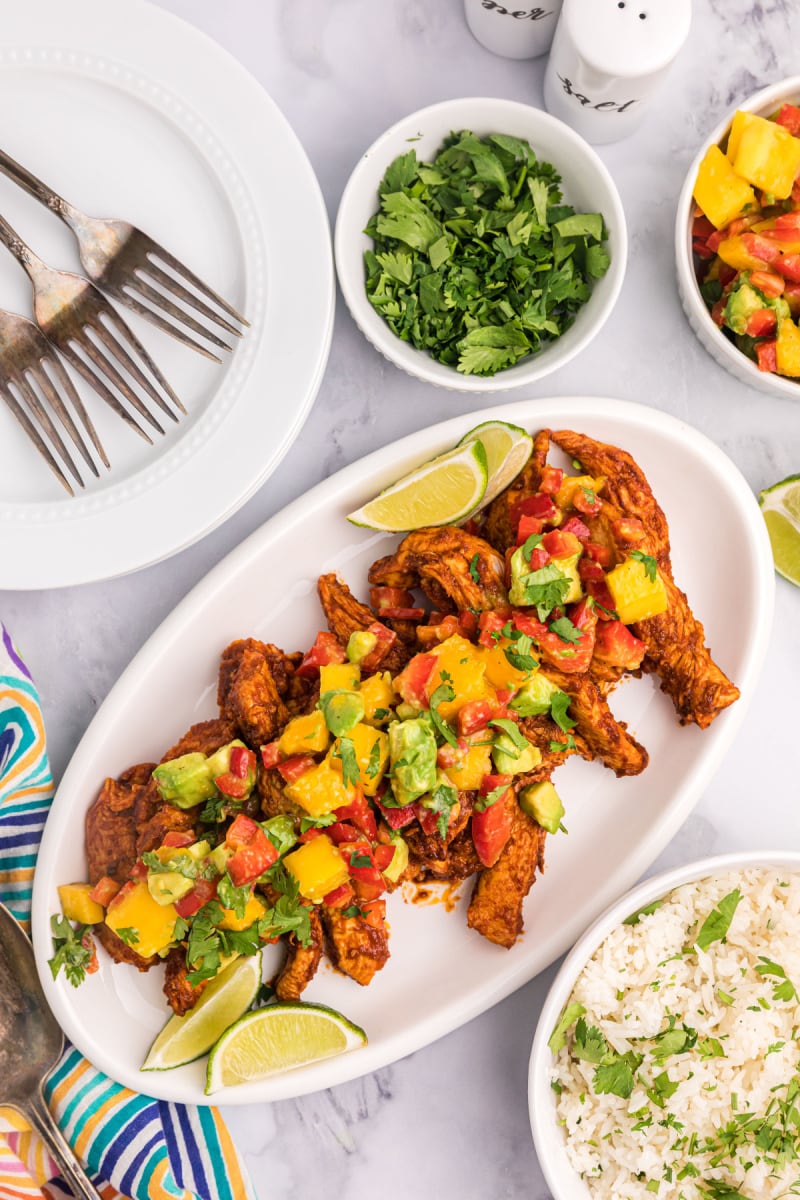 platter of chili rubbed chicken with mango salsa