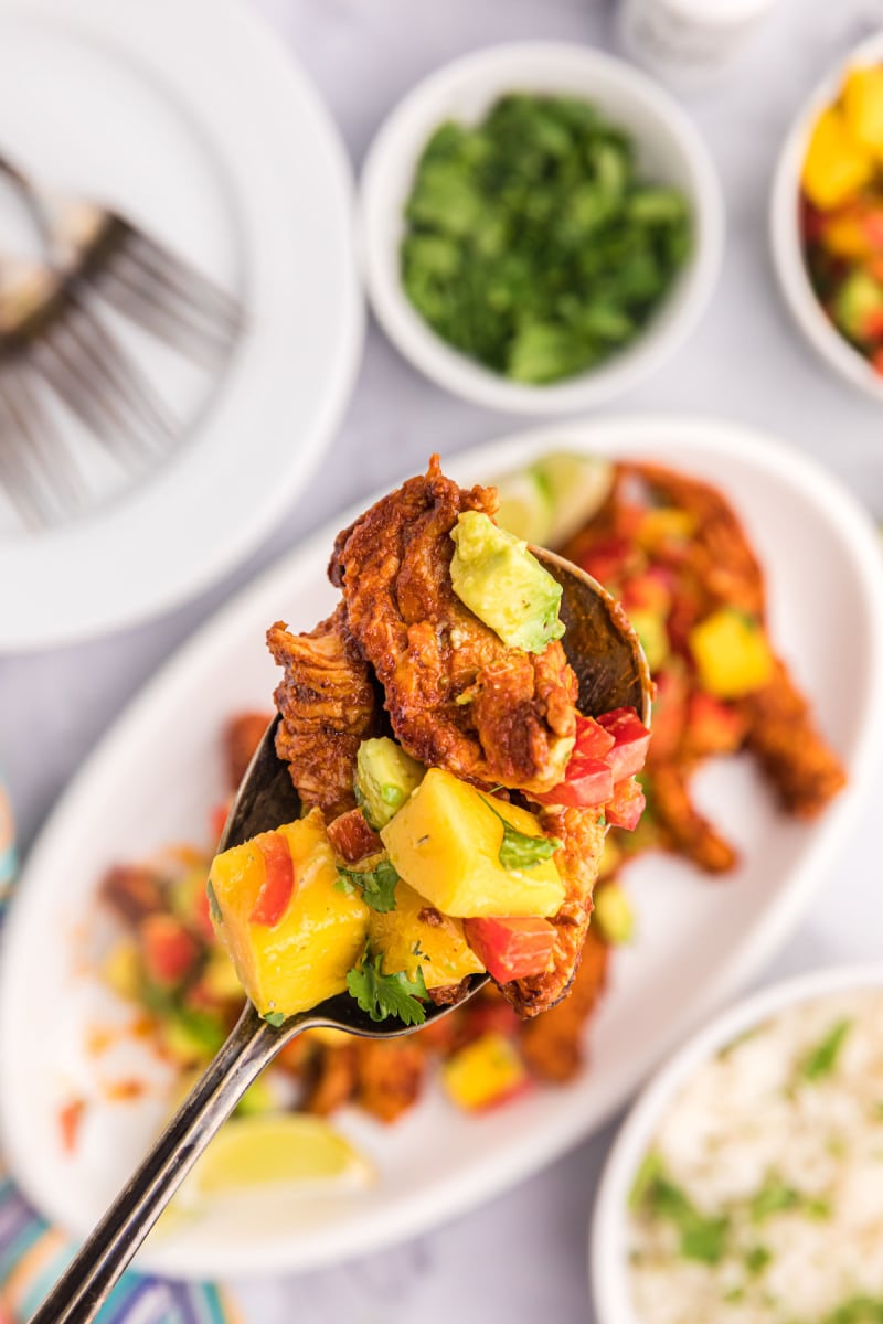 chili rubbed chicken with mango salsa on plate