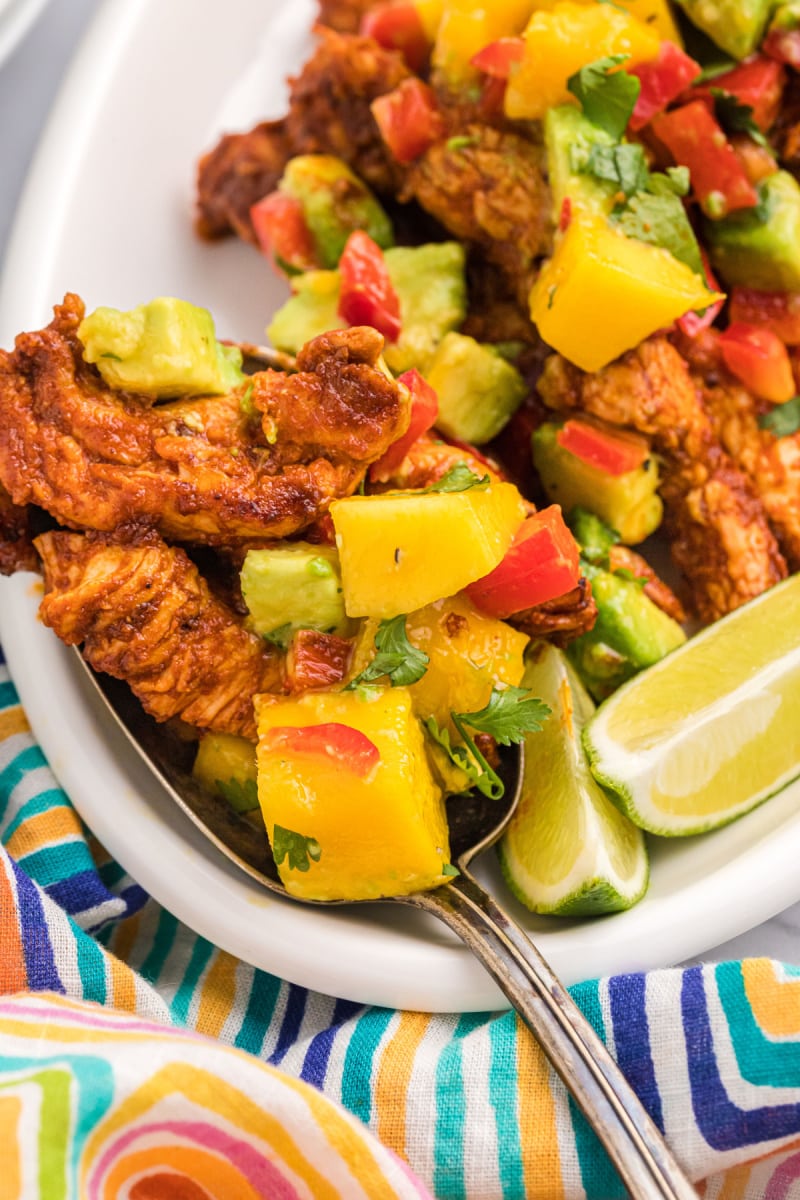 chili rubbed chicken on a plate with mango salsa