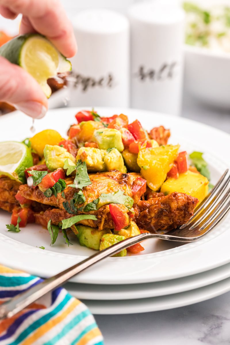 chili rubbed chicken with mango salsa on plate