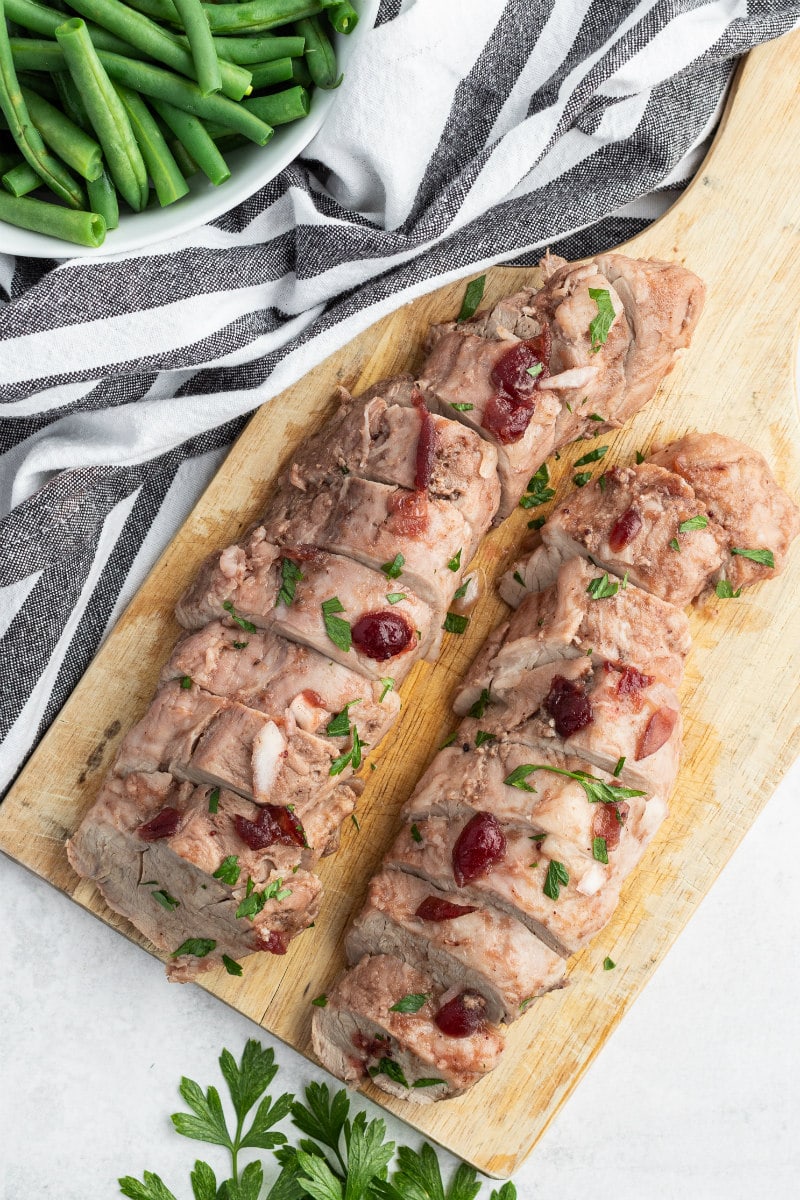 sliced pork tenderloin on cutting board