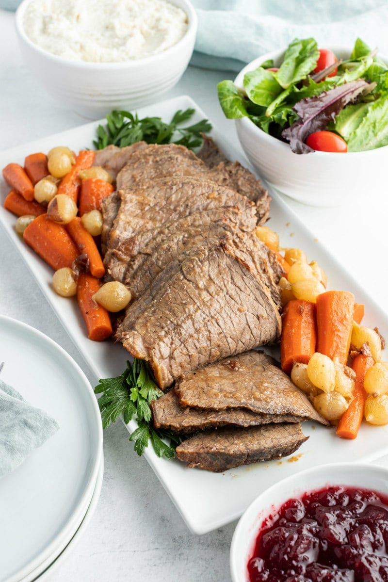 cranberry roast beef on a platter with vegetables