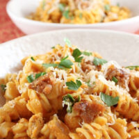 creamy pumpkin pasta with sausage in a bowl