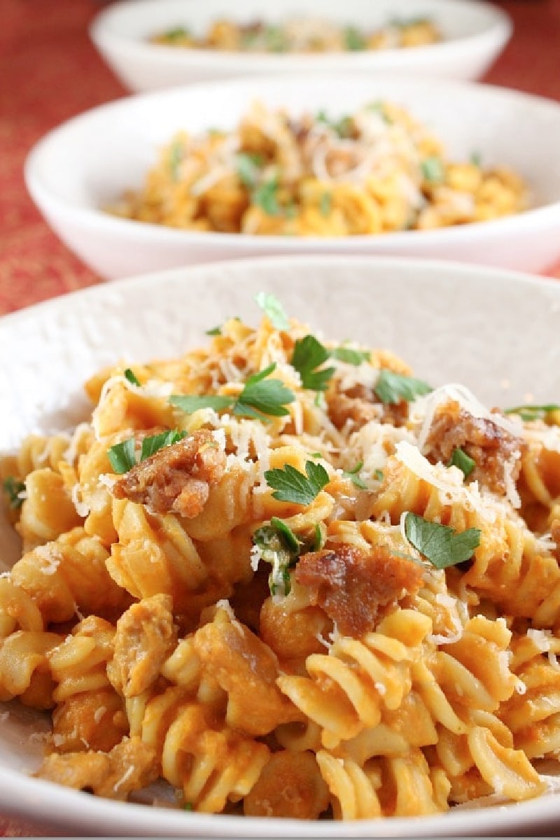 Creamy Pumpkin Pasta with Sweet Italian Sausage recipe from RecipeGirl.com #pumpkin #pasta #italian #sausage #recipe #RecipeGirl creamy pumpkin pasta with sausage in a bowl