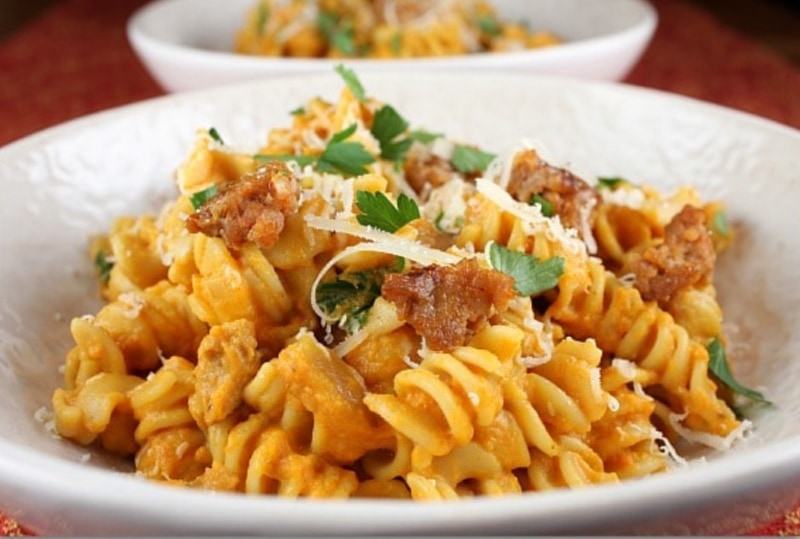 Creamy Pumpkin Pasta with Sweet Italian Sausage recipe from RecipeGirl.com #pumpkin #pasta #italian #sausage #recipe #RecipeGirl pumpkin pasta with sausage in a bowl