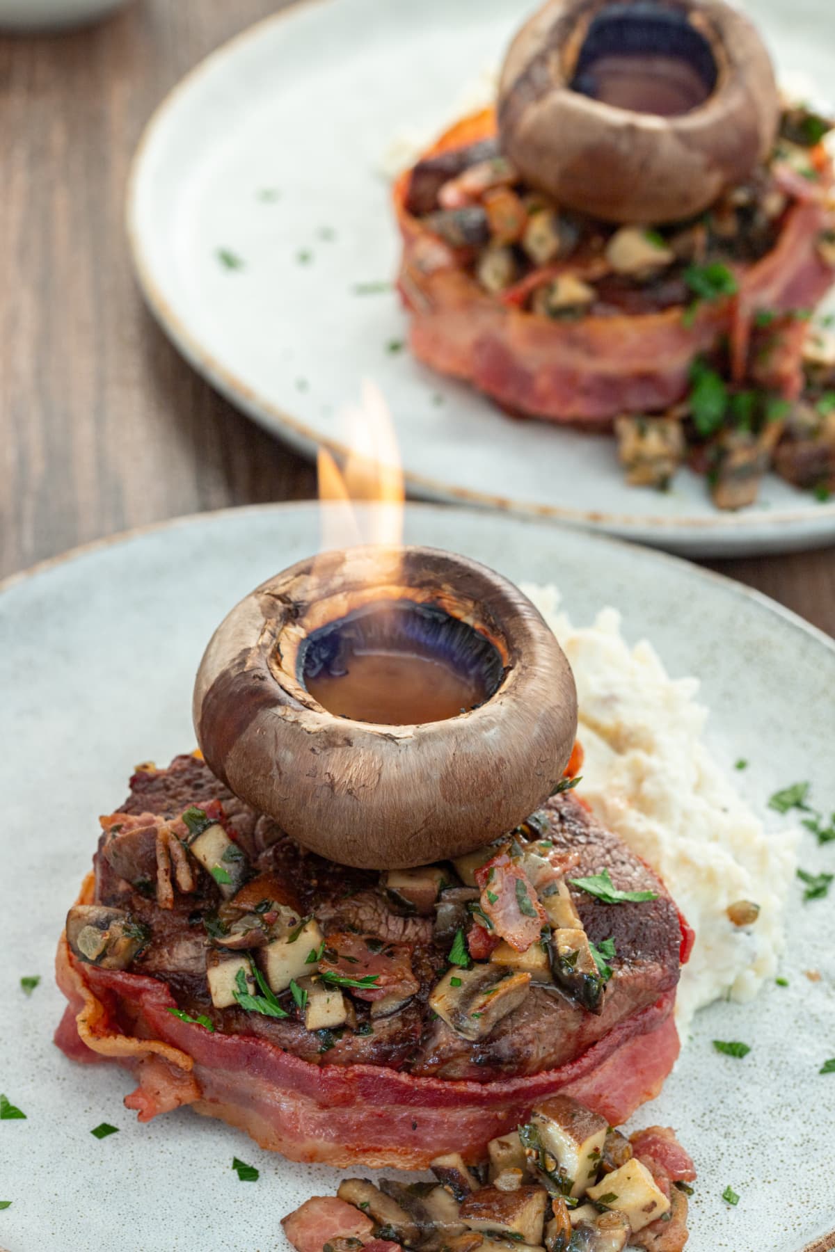 mushroom cap set on fire on top of filet mignon