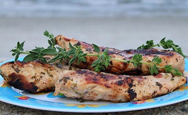 Grilled Chicken with Lemon and Oregano on a blue plate with fresh oregano