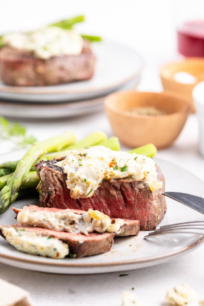 steak on plate topped with blue cheese sauce