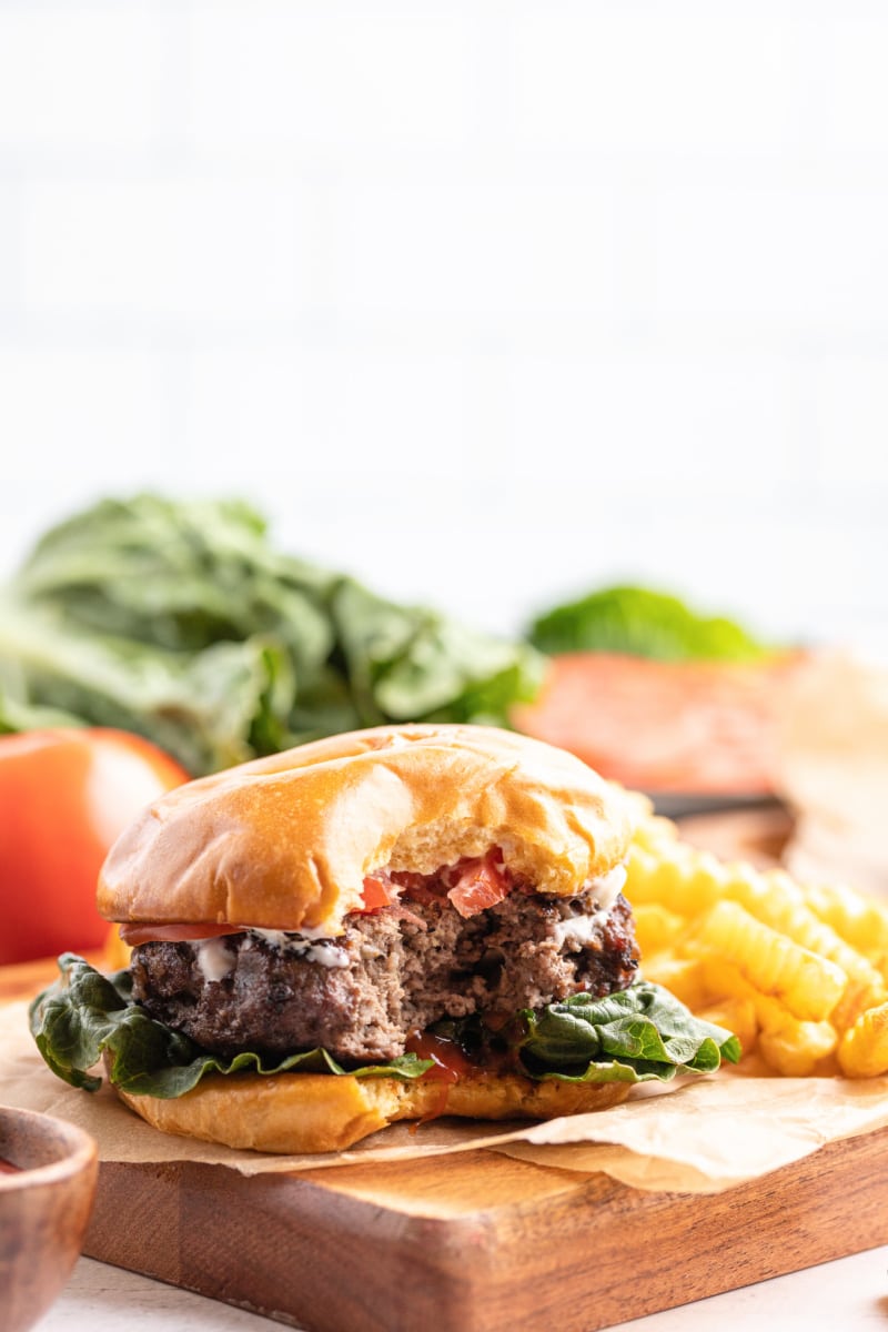 Hamburgers with Cabernet and Sauteed Onions #hamburgers #burgers #cabernet #sauteedonions #recipe #RecipeGirl hamburger with bite taken out of it