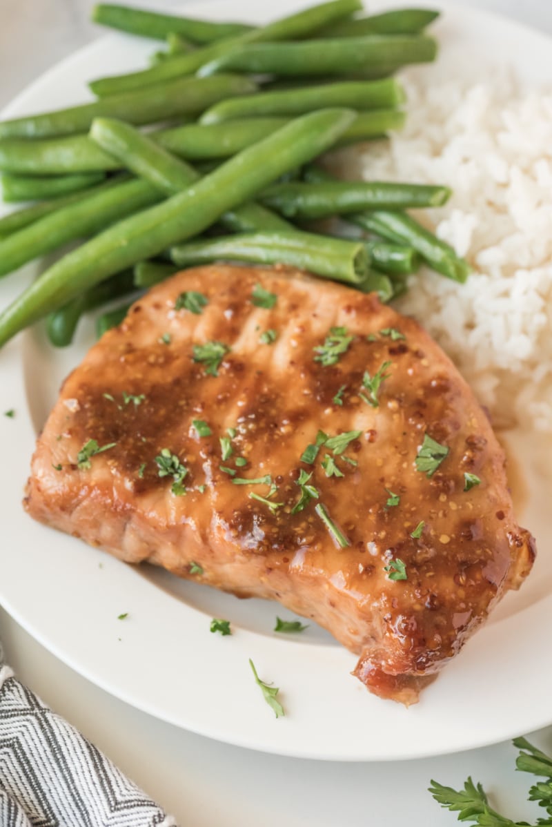 pork chop on plate with green beans and rice