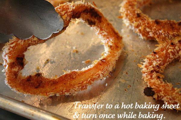 Baked BBQ Onion Rings - no dipping sauce needed because the barbecue sauce is baked right in! recipe from RecipeGirl.com #baked #bbq #barbecue #onionrings #recipe #RecipeGirl How to Make Baked BBQ Onion Rings - Bake on a hot baking sheet