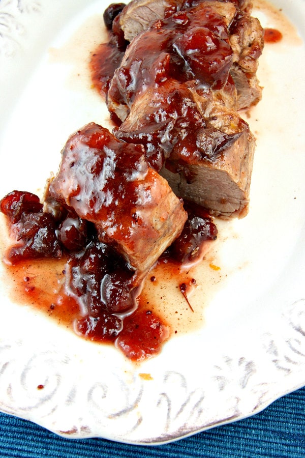 Orange Cranberry Glazed Pork Tenderloin on a white platter