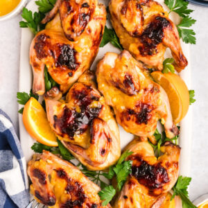pinterest image for orange glazed cornish hens
