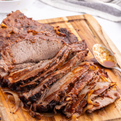 oven baked barbecue brisket on a cutting board sliced