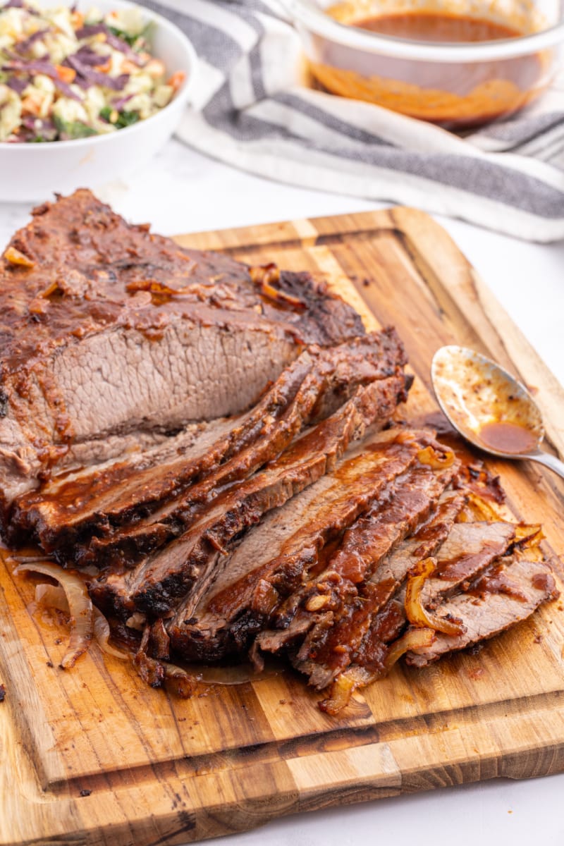 oven baked barbecue brisket on a cutting board sliced