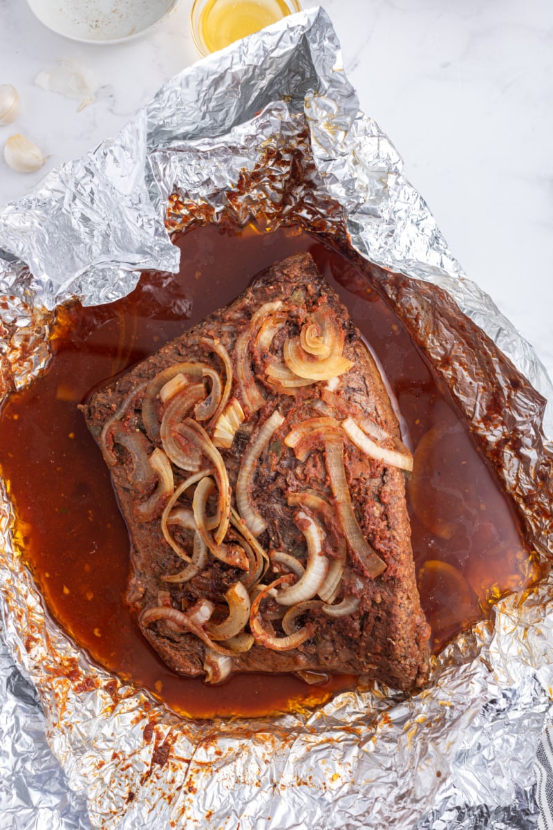 barbecue brisket just out of the oven wrapped in foil