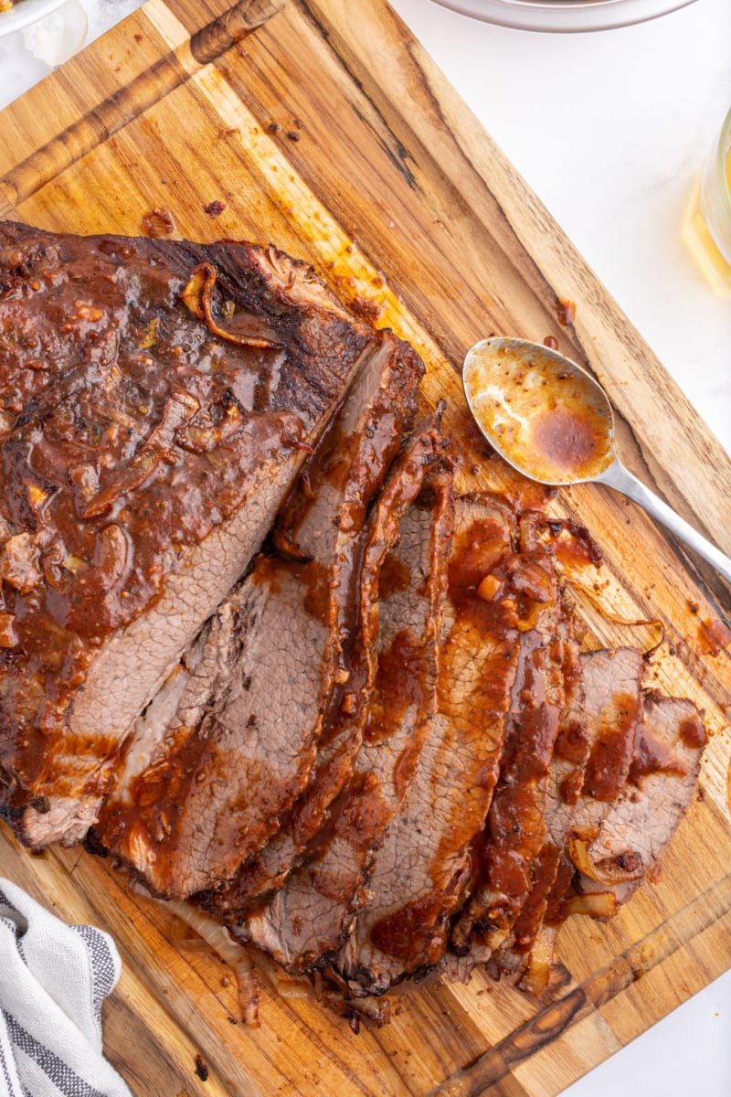 oven baked barbecue brisket on a cutting board sliced