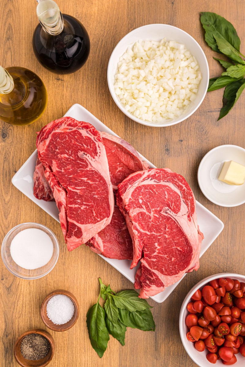 ingredients displayed for making pan seared ribeye steak with balsamic onion and tomato salsa