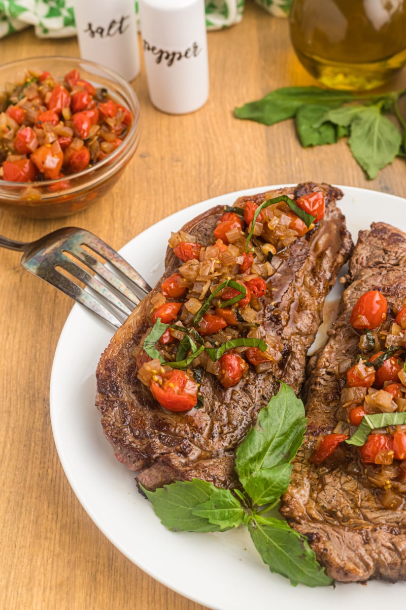 pan seared ribeye steak with salsa on plate