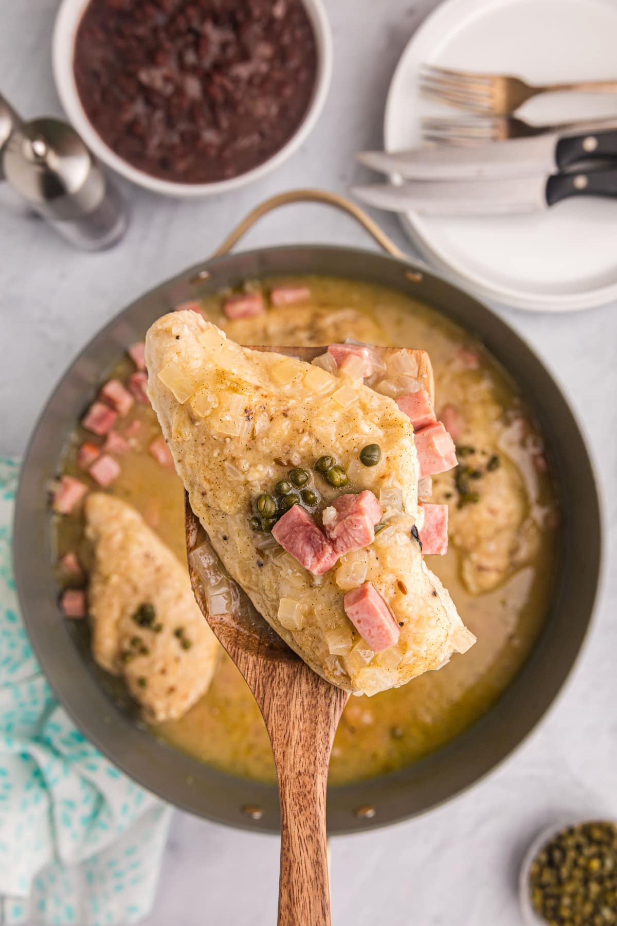 spatula picking up piece of pollo borracho out of pan