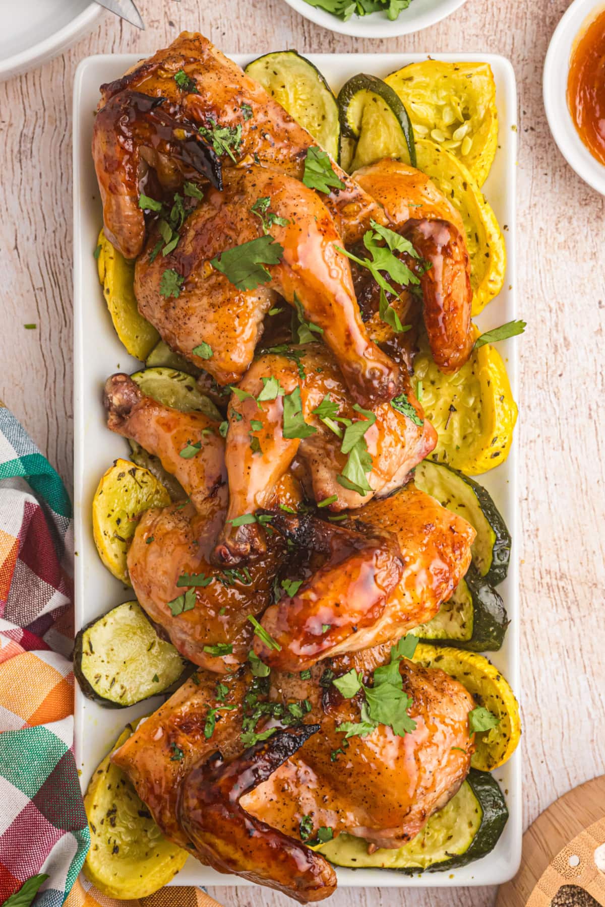 roasted apricot ginger glazed game hens on a platter with veggies