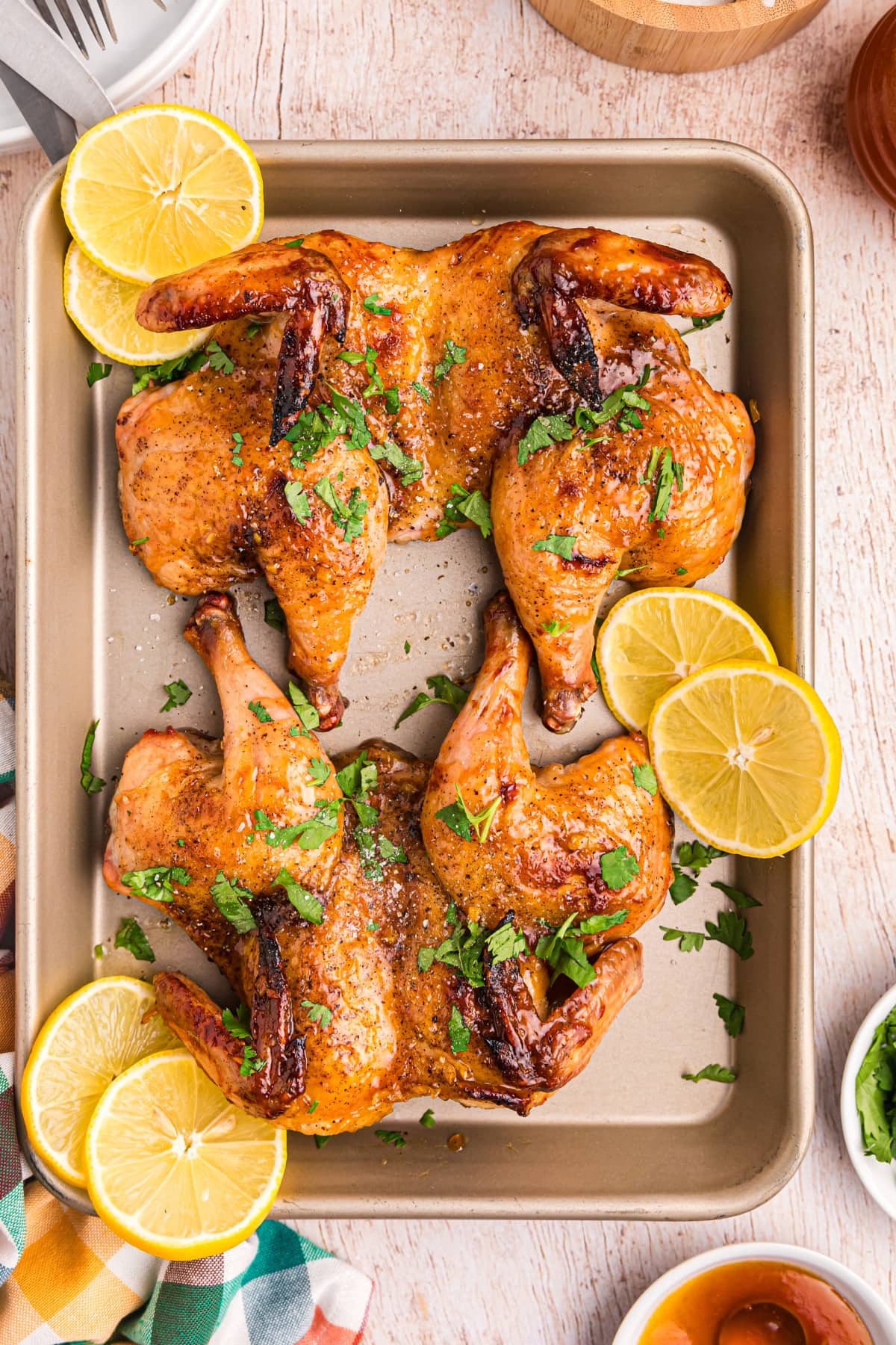 roasted apricot ginger glazed game hens on a baking sheet