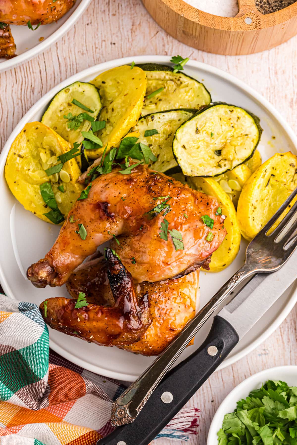 serving of game hen on a plate with vegetables